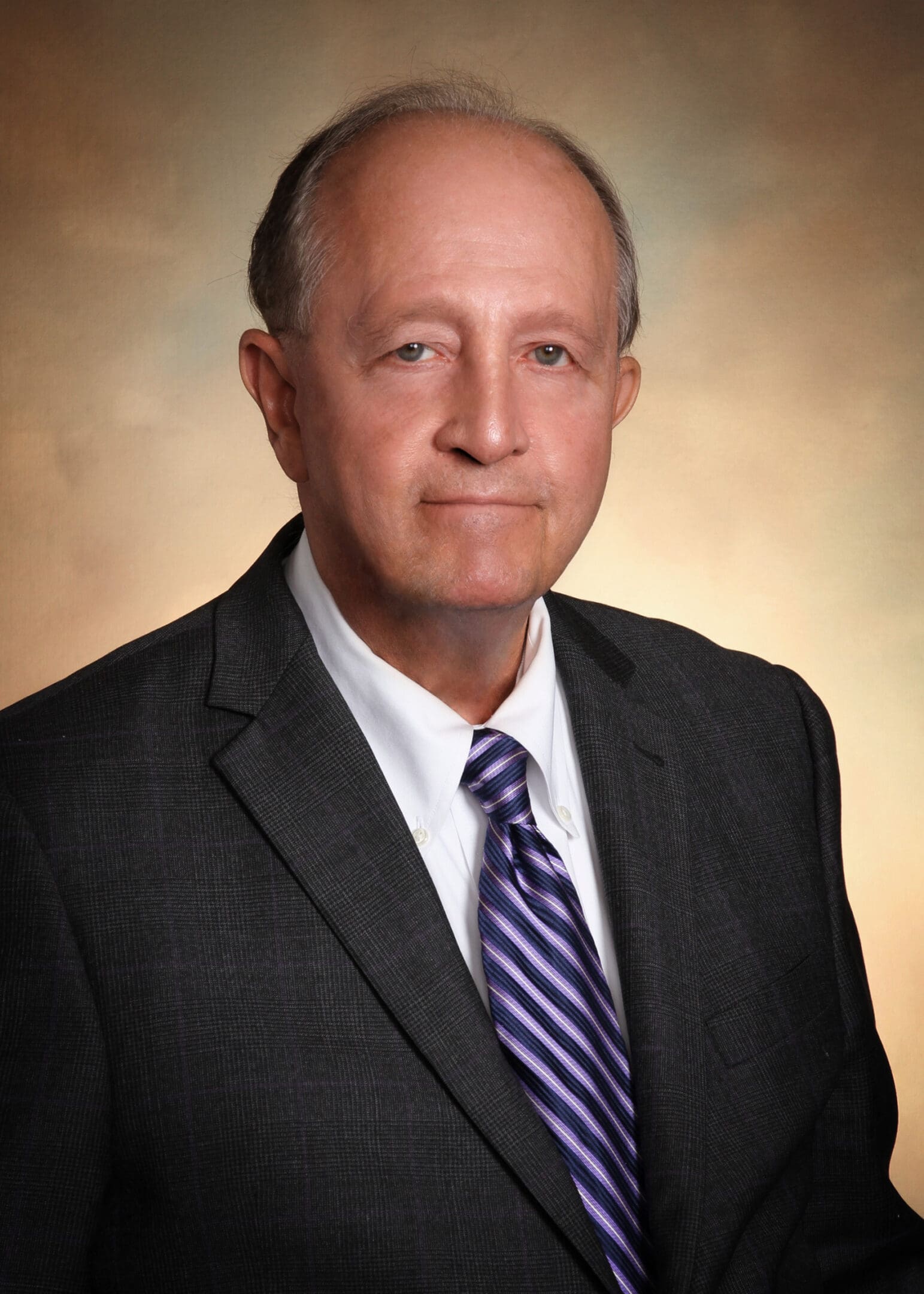 A man in a suit and tie standing up.